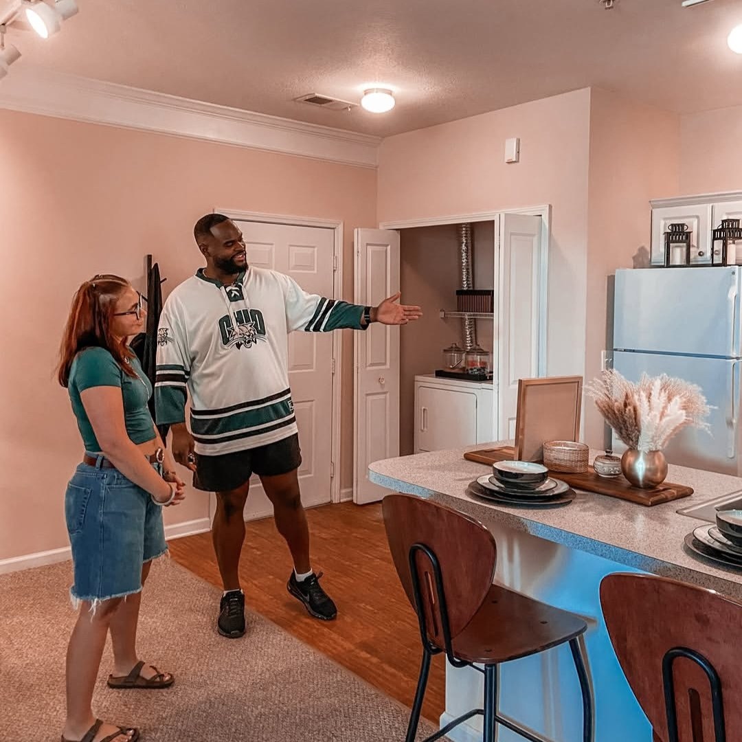 me and my coworker practicing tours of our model unit for a social media post